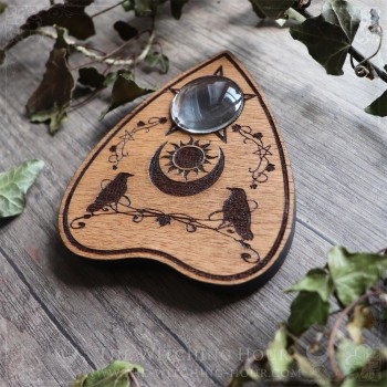 Ouija planchette with crows and a moon crescent