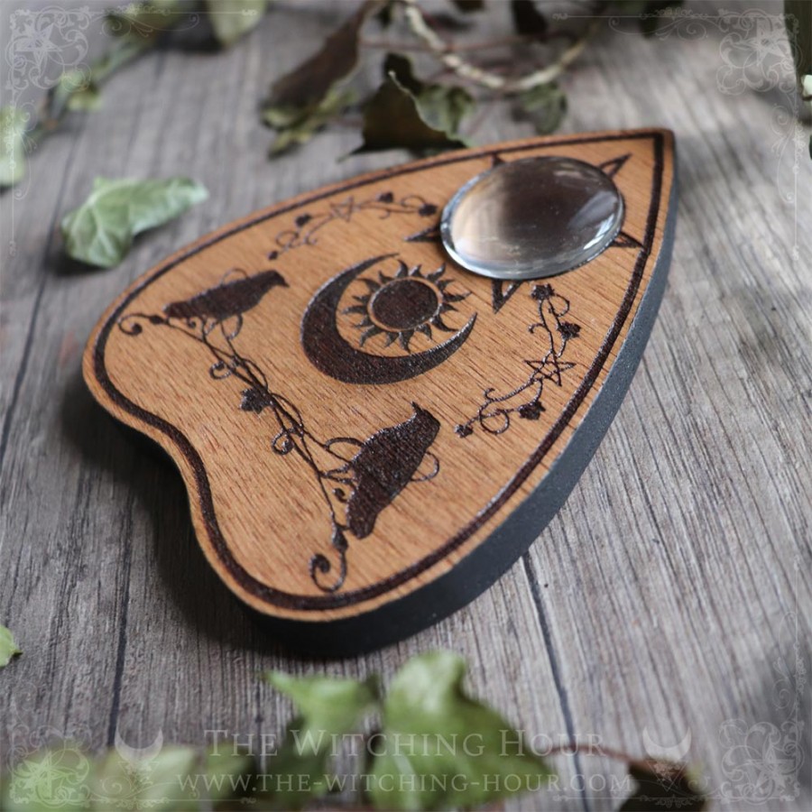 Ouija planchette with crows and a moon crescent