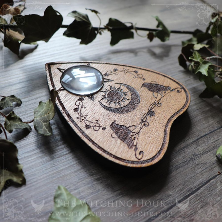 Ouija planchette with crows and a moon crescent