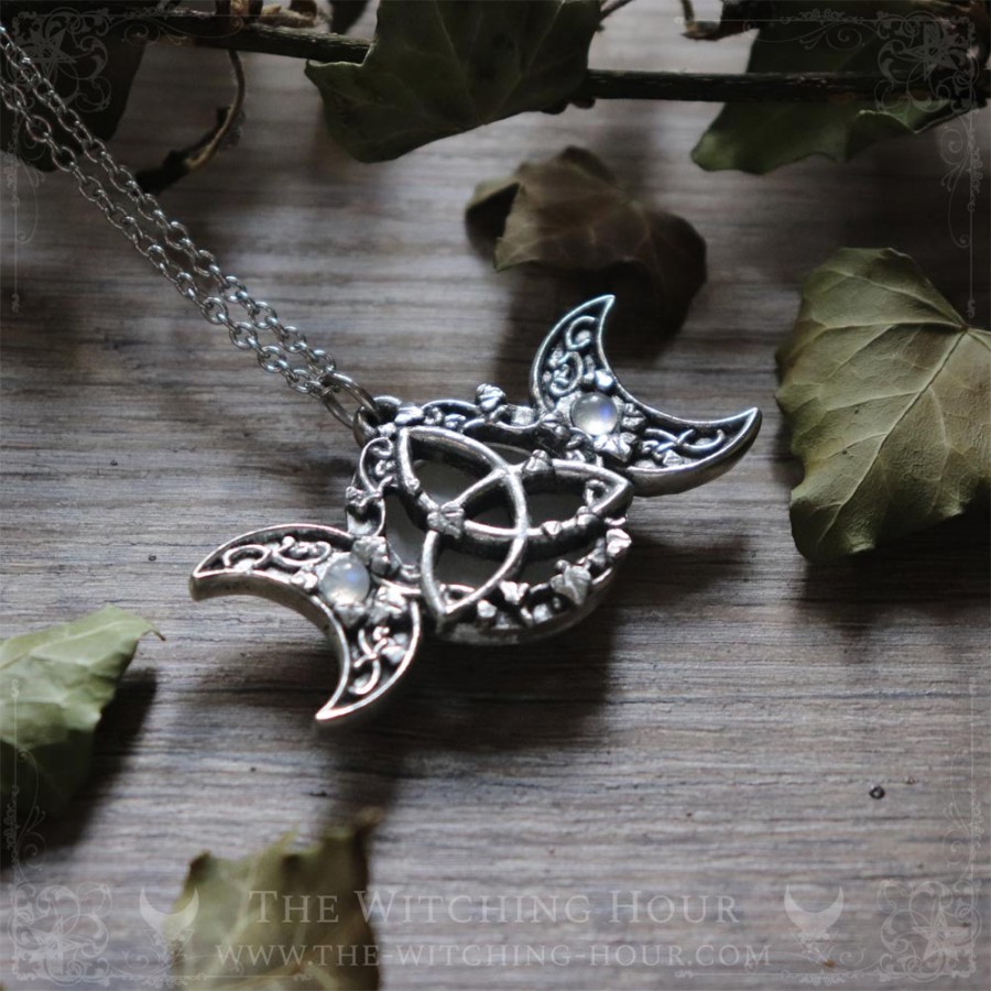 Triple moon and triquetra necklace surrounded by leaves