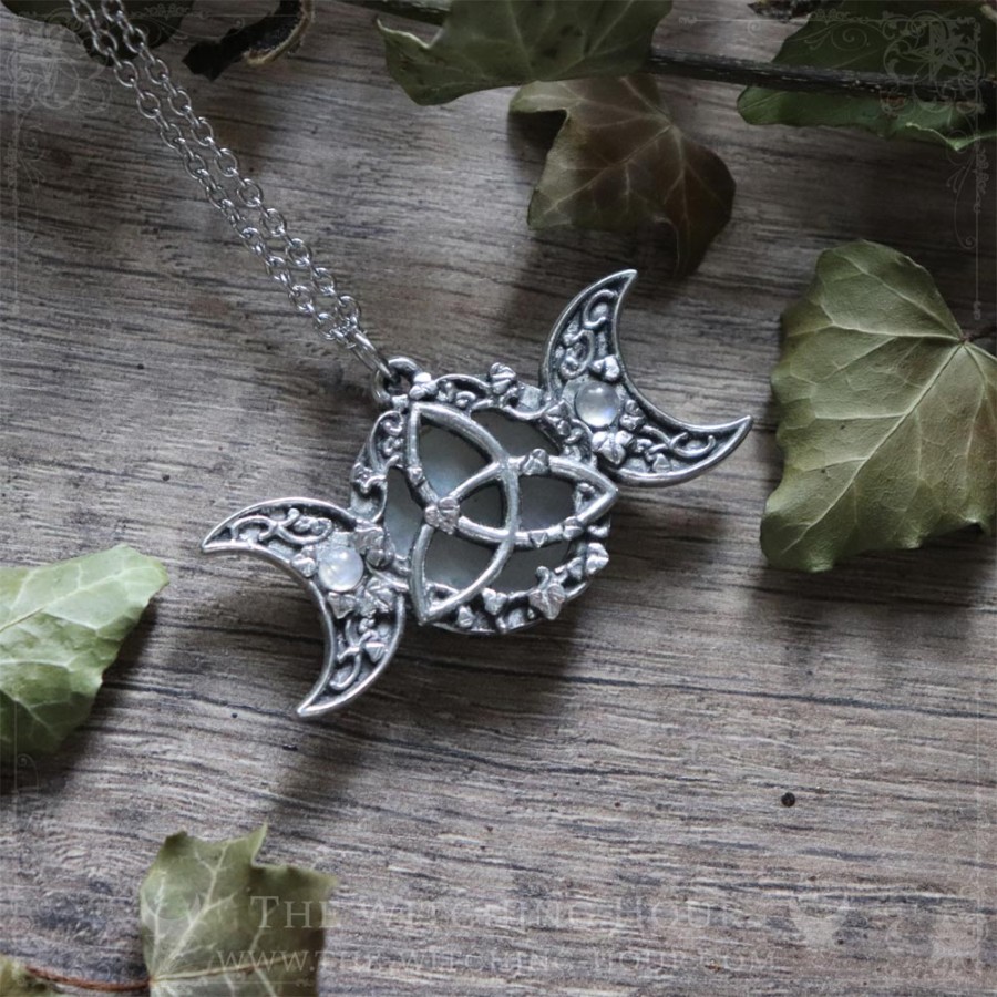 Triple moon and triquetra necklace surrounded by leaves